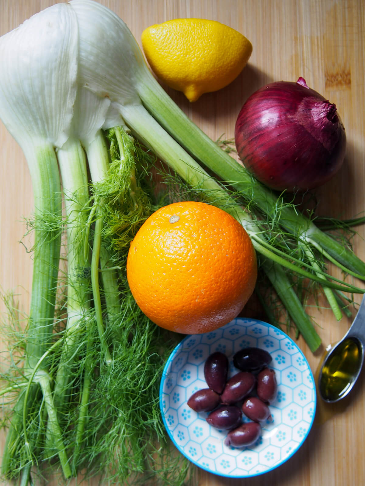 ingredients for Sicilian fennel orange salad laid out on chopping board (before chopping)