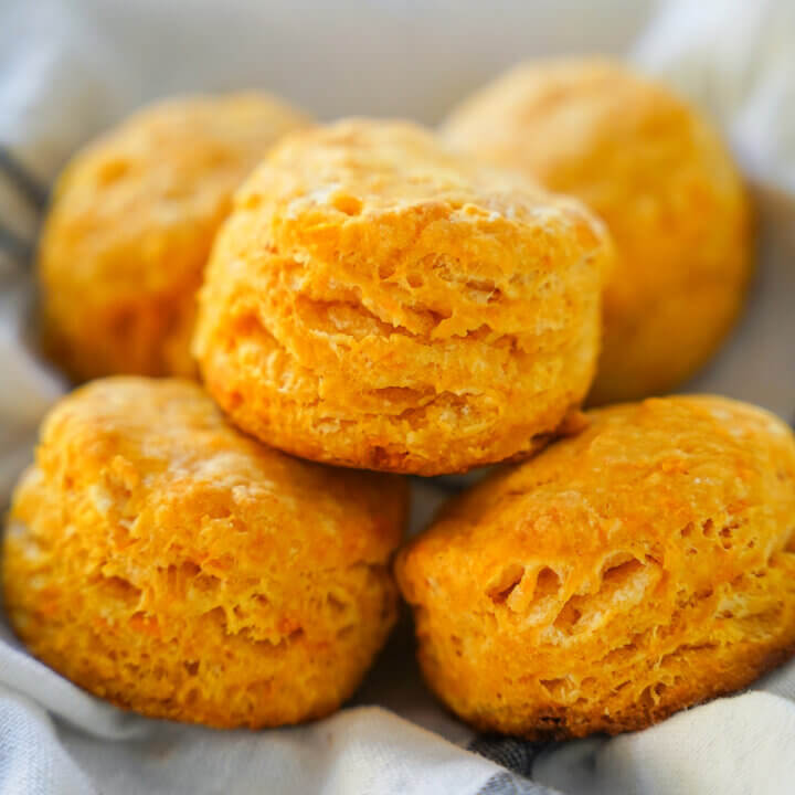 five sweet potato biscuits stacked on top of each other in cloth.