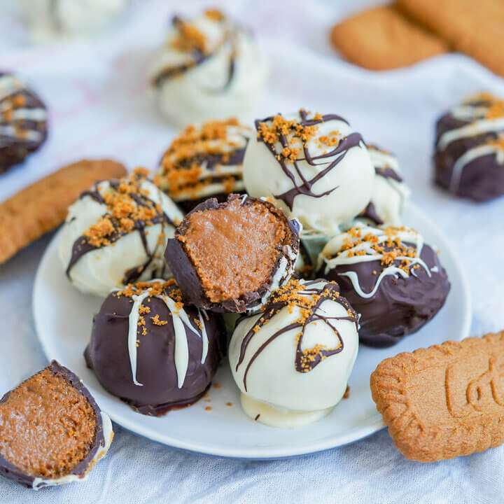 small plate of biscoff truffles with one cut sitting on top.